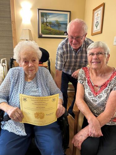 Sr. Carol Clark PGM and Bro. Bill Clark PGP present Sister Jean Jamieson with her 75-year pin and certificate. Jean joined in Scotland in 1948. [Presented July 2023]